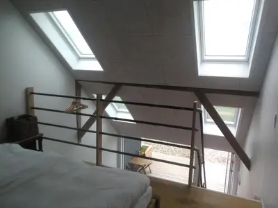 a bedroom with a bed and a large window at Rikke og Franks Svineri in Lemvig