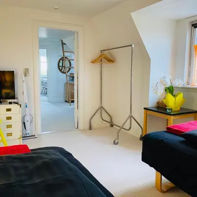 a bedroom with a bed and a desk and a room at Event4U in Nykøbing Mors