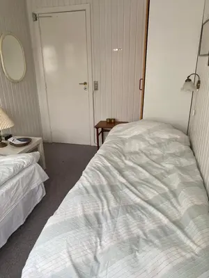 a bedroom with a white bed and a mirror at Munkebo B&B, Thy in Thisted