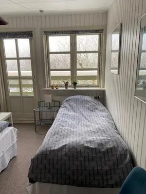 a bedroom with a bed and two windows at Munkebo B&B, Thy in Thisted