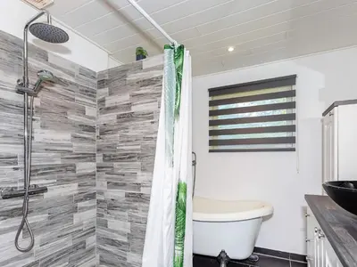 a bathroom with a shower with a toilet and a sink at 6 person holiday home in Løgstør in Løgstør
