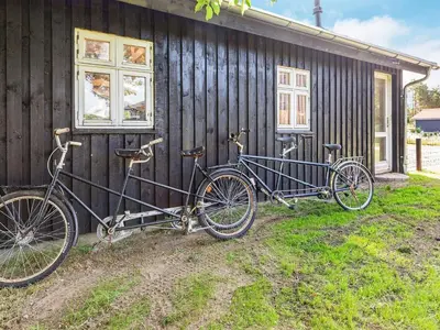 two bikes are parked outside of a building at 6 person holiday home in Løgstør in Løgstør