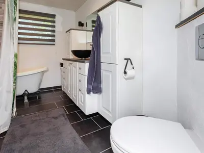 a bathroom with a toilet and a sink and a tub at 6 person holiday home in Løgstør in Løgstør