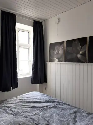 a bedroom with a bed and a window at Latinerkvarteret in Viborg