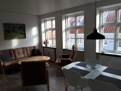 a living room with a couch and a table at Latinerkvarteret in Viborg