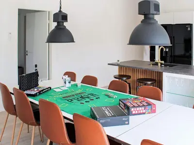 a dining room with a table with a laptop on it at 10 person holiday home in Vinderup-By Traum in Vinderup