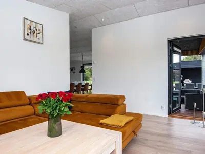 a living room with a couch and a table at 10 person holiday home in Vinderup-By Traum in Vinderup