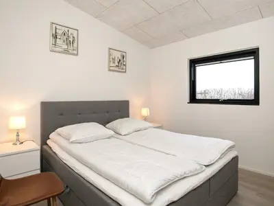 a bedroom with a large white bed with a window at 10 person holiday home in Vinderup-By Traum in Vinderup