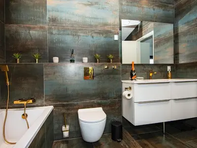 a bathroom with a tub and a toilet and a sink at 10 person holiday home in Vinderup-By Traum in Vinderup