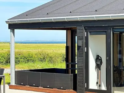 a screened in porch with a view of a field at 10 person holiday home in Vinderup-By Traum in Vinderup