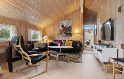 a living room with a couch and a table at Holiday Home Odavej Løkken Xi in Løkken