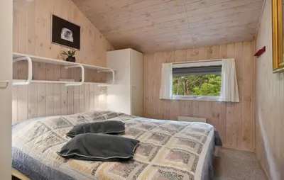 a bedroom with a bed with two pillows on it at Holiday Home Odavej Løkken Xi in Løkken