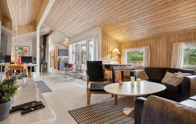 a living room with a couch and a table at Holiday Home Odavej Løkken Xi in Løkken