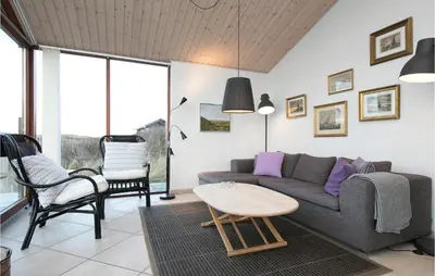 a living room with a couch and a table at Holiday Home Ruthsvej in Løkken