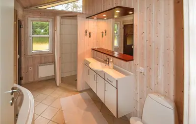 a bathroom with a sink and a toilet at Holiday Home Sarasvej Løkken in Løkken