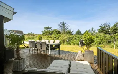 a deck with a couch and a table and chairs at 4 Bedroom Nice Home In Saltum in Saltum