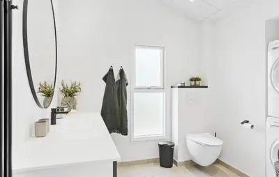 a white bathroom with a toilet and a sink at 4 Bedroom Nice Home In Saltum in Saltum