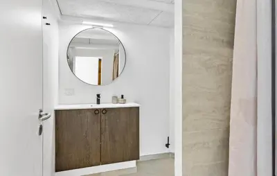 a bathroom with a wooden vanity and a mirror at 4 Bedroom Nice Home In Saltum in Saltum