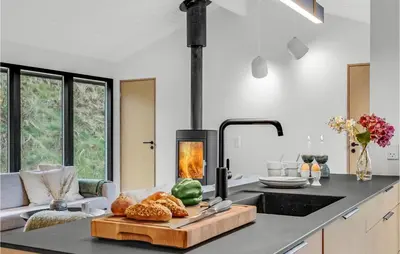 a kitchen with a stove and a table with bread at Nice Home In Saltum With Kitchen in Saltum