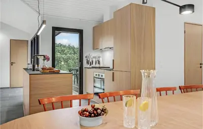 a kitchen and dining room with a table and chairs at Nice Home In Saltum With Kitchen in Saltum