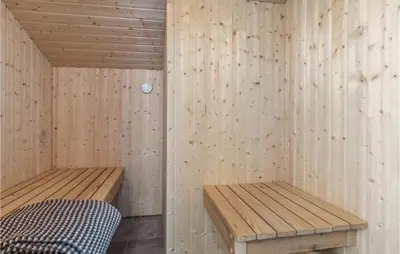 a sauna with two benches and a bed in it at Nice Home In Saltum With Kitchen in Saltum