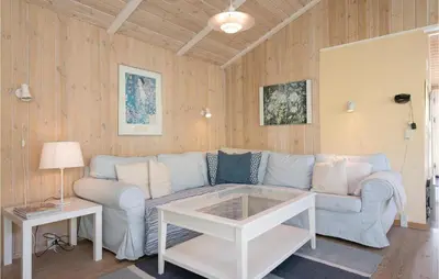 a living room with a couch and a table at Holiday Home Moreavej in Blokhus