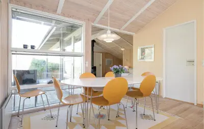 a dining room with a table and chairs at Holiday Home Moreavej in Blokhus