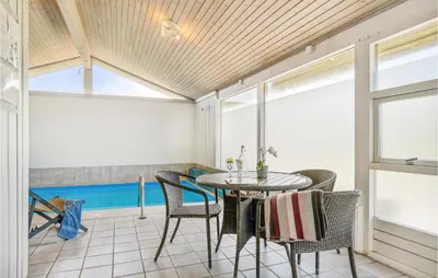 a dining room with a table and chairs at Pet Friendly Home In Pandrup With Sauna in Pandrup