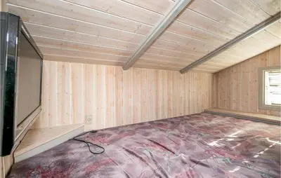 a room with a tv in a room with wooden walls at Holiday Home Østersvej Fjerritslev Xii in Fjerritslev