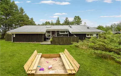a house with a sandbox in the yard at Holiday Home Harestien Brovst in Brovst