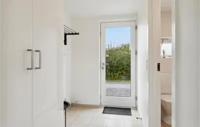 a bathroom with a door leading to a toilet at Holiday Home Kronvildtvej Brovst Ii in Brovst