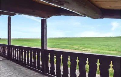 a balcony with a view of a green field at 9 Bedroom Beautiful Home In Lemvig in Lemvig