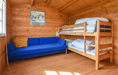 a living room with a couch and bunk beds at Holiday Home Kjeldbjergvej Lemvig Iii in Lemvig