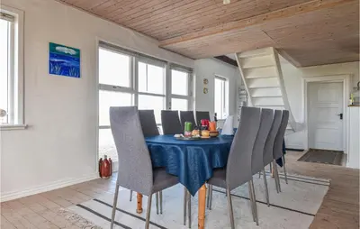 a dining room with a blue table and chairs at Holiday Home Kjeldbjergvej Lemvig Iii in Lemvig