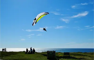 a person is flying a kite on the beach at Klitborgen in Harboør