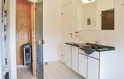 a bathroom with a sink and a mirror at Holiday Home Klitengene Xi in Ulfborg