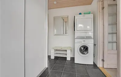 a laundry room with a washing machine and a washer at Holiday Home Doblervej Harboøre X in Harboør