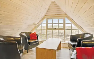 a room with chairs and a table and a window at Holiday Home Doblervej Harboøre Denm in Harboør