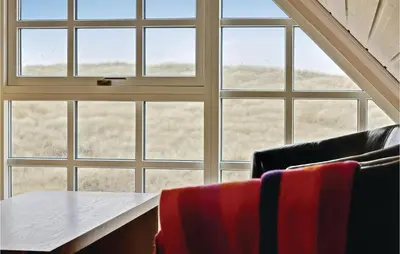 a room with a table and chairs and a window at Holiday Home Doblervej Harboøre Denm in Harboør