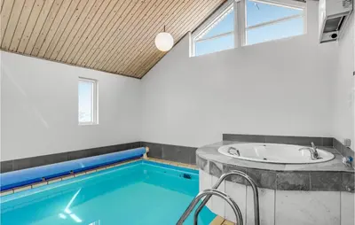 a bathroom with a sink and a swimming pool at Stunning Home In Thisted With Sauna in Thisted