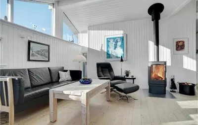 a living room with a couch and a fire place at Åbo in Thisted