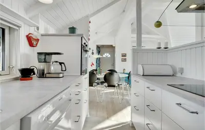 a kitchen with white counters and white cabinets at Åbo in Thisted