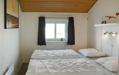 a bedroom with two beds and a window at Nice Home In Thisted With Sauna in Thisted