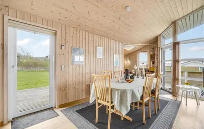 a dining room with a table and chairs at Holiday Home Hannesvej V in Vestervig