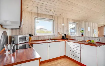 a kitchen with white cabinets and a microwave at Holiday Home Hannesvej V in Vestervig