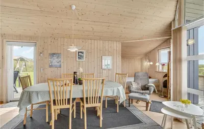 a dining room with a table and chairs at Holiday Home Hannesvej V in Vestervig