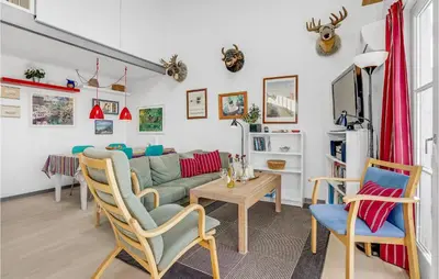 a living room with a couch and a table at Holiday Home Havnevej in Vestervig