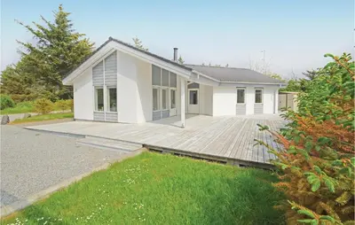a house with a large deck in front of it at Holiday Home Sivsangervej Vestervig X in Vestervig