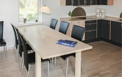 a kitchen with a table and chairs with a box on it at Holiday Home Sivsangervej Vestervig X in Vestervig
