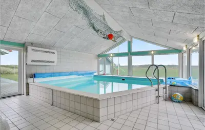a large swimming pool in a room with a large window at Amazing Home In Thisted With Sauna in Thisted